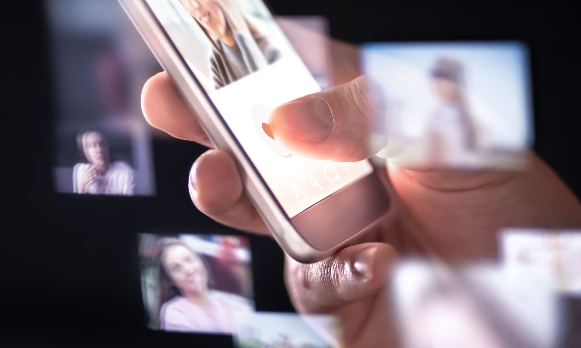 Online dating app or site in mobile phone. Finding love and romance from internet with smartphone. Man giving like. Many hologram photos of beautiful woman around cellphone.